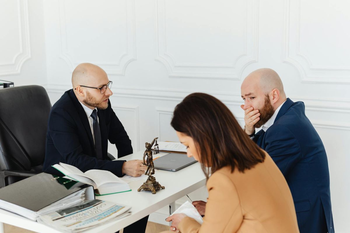 Bald Covering His Mouth While Looking at the Woman