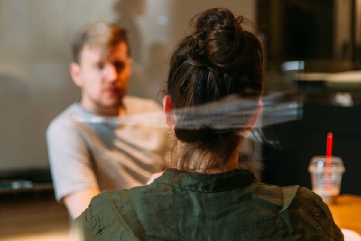 person sitting in a chair in front of a man